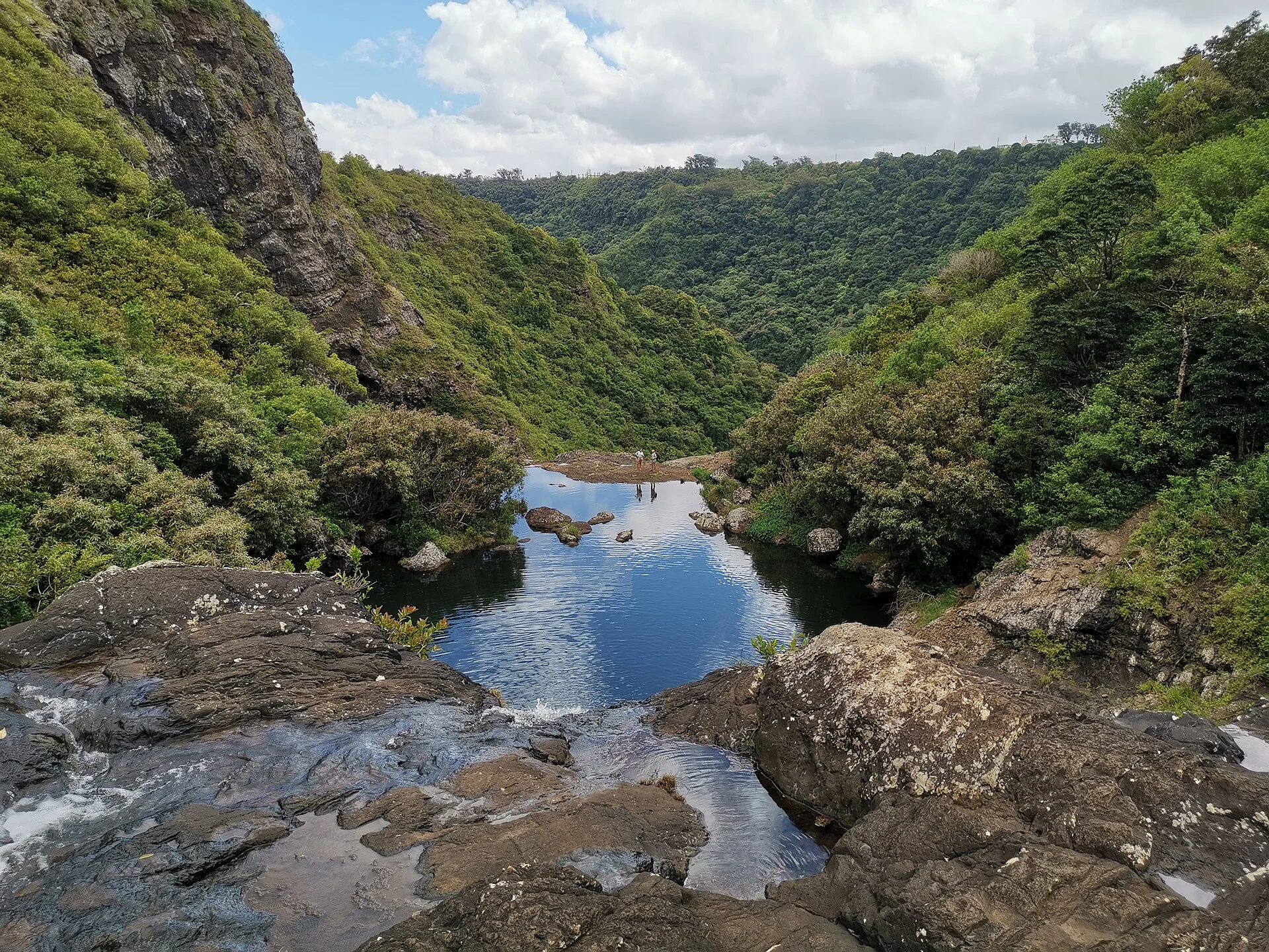 Rocky pools between the forested cliffs at Tamarind Falls