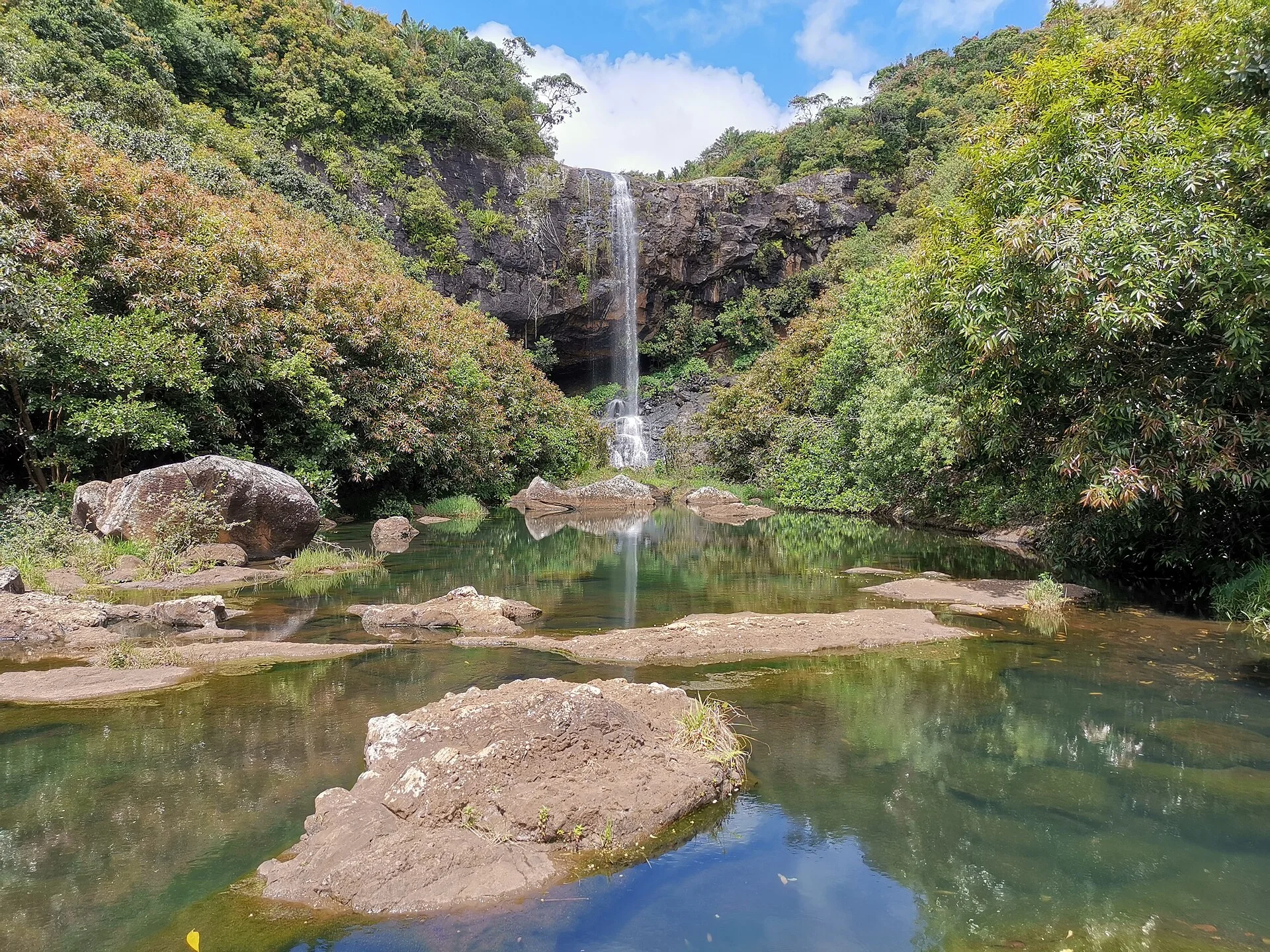 A waterfall dropping into a pool below the cliffs at Tamarind Falls